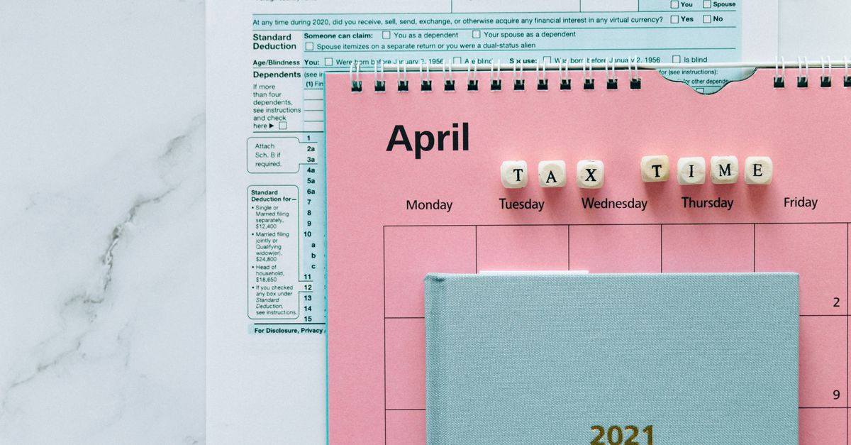 April calendar with tax forms, highlighting tax time reminders for financial tasks.