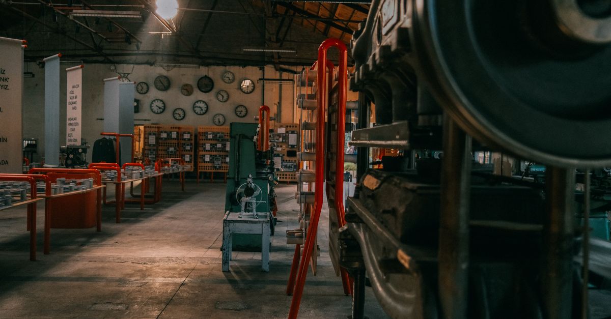 A rustic industrial workshop filled with vintage machinery and tools.